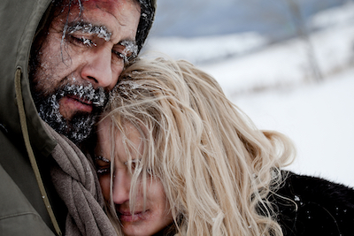 Close-up of freezing homeless couple struggle and hug