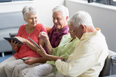 Seniors using tablets in a retirement home