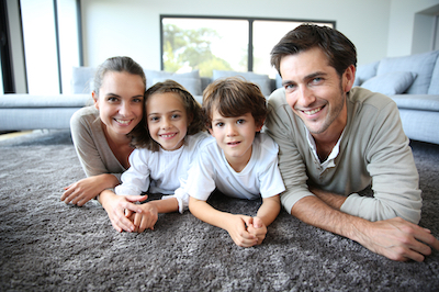 Family at home relaxing on carpet