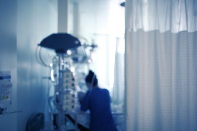 Nurse caring for the patient in the intensive care unit.