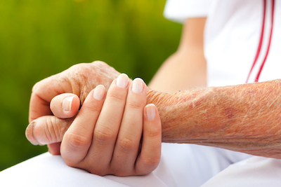 Doctor holding hand of an elderly woman