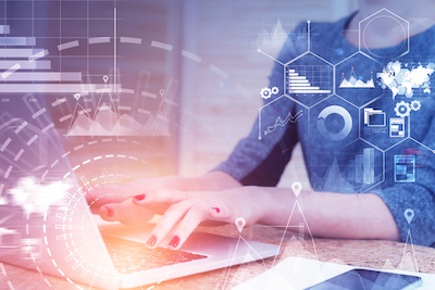 Unrecognizable woman in gray typing on laptop in office. Hud and infographics interface foreground. Toned image double exposure. Elements of this image furnished by NASA